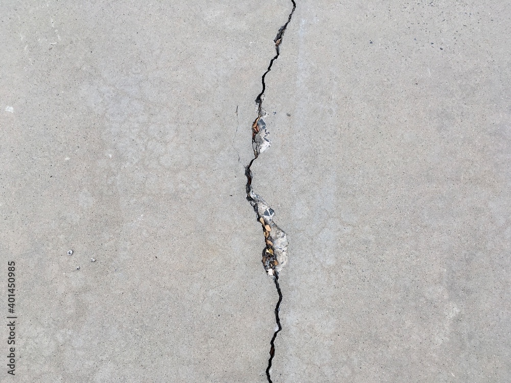 big crack in the middle of cement driveway