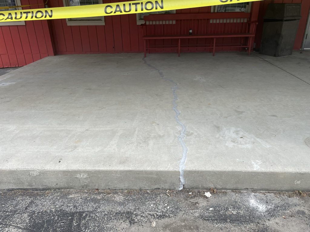 cement landing with caution tape above it